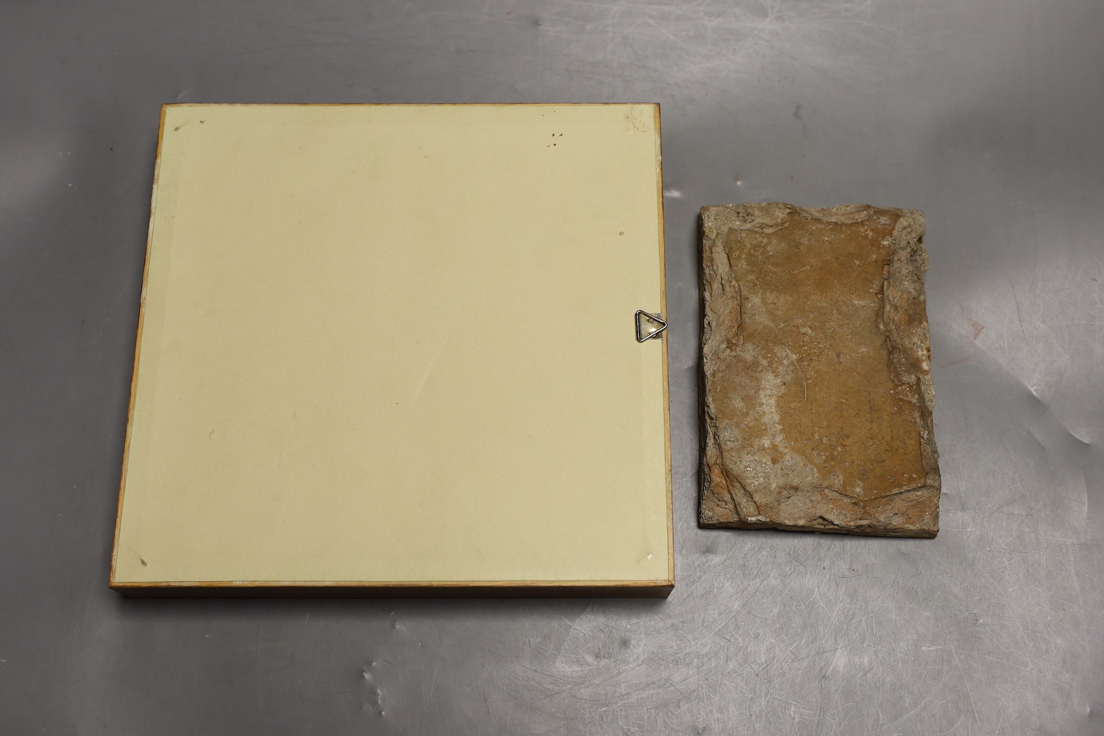A Spanish tin-glazed earthenware floor tile, 16th/17th century and a larger tile, possibly Italian, largest 19cms